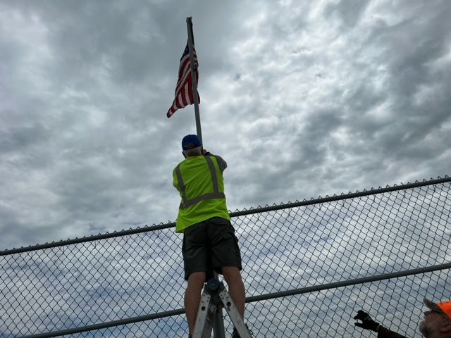 Community Veterans and Auxiliary members changing out tattered flags on the Ave H overpass, Kearney, NE. 