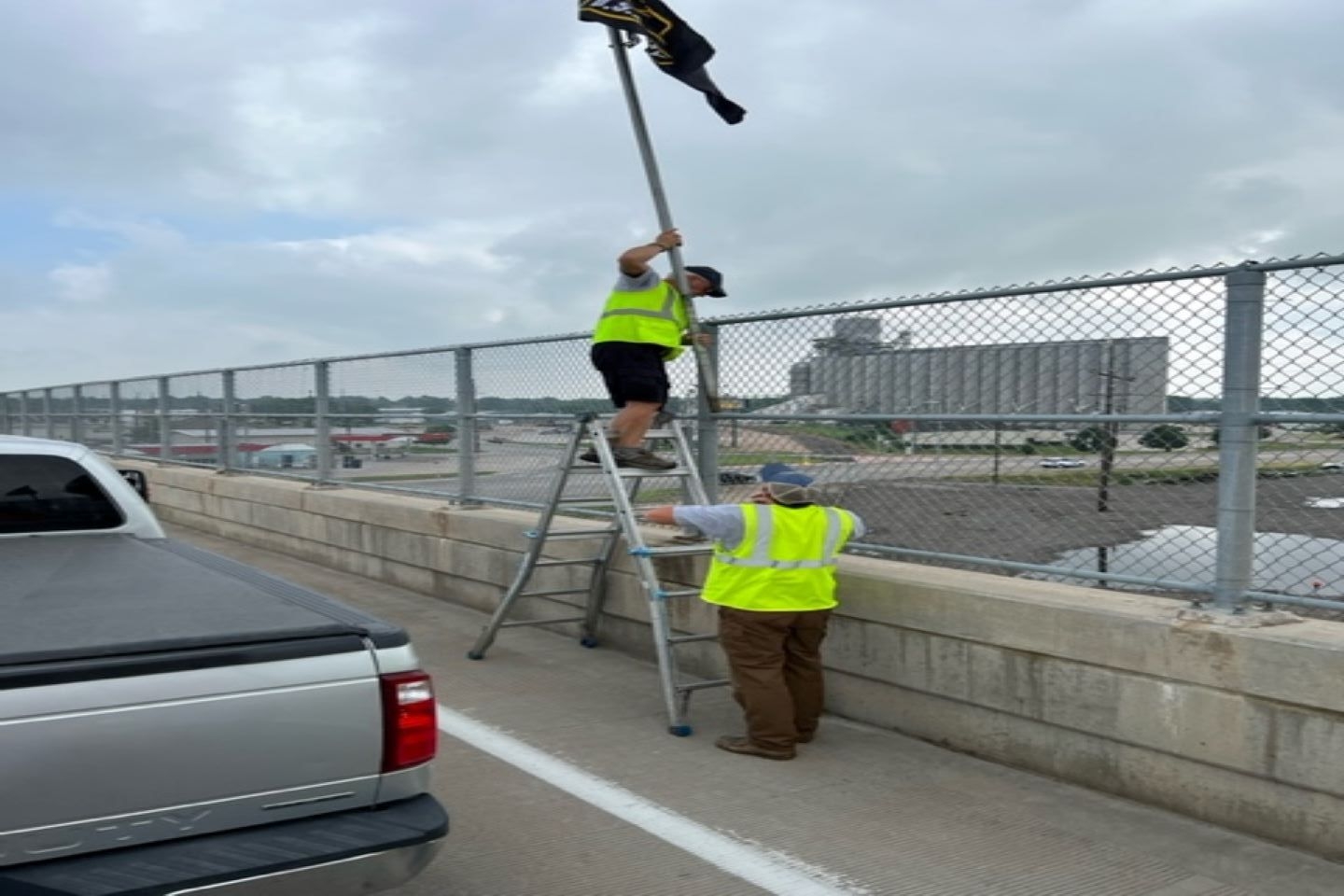 Community Veterans and Auxiliary members changing out tattered flags on the Ave H overpass, Kearney, NE. 