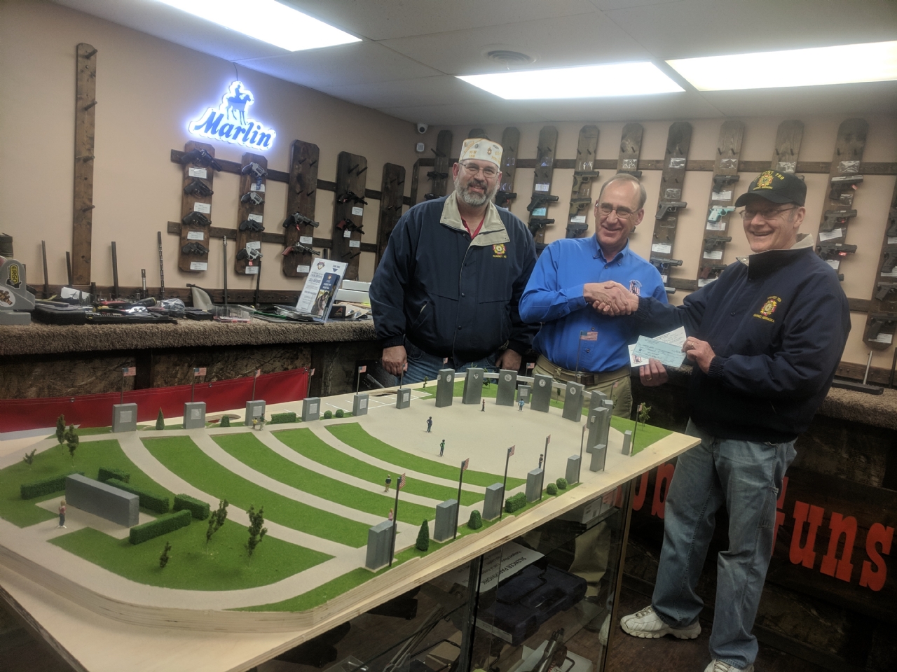 Post Commander John Kruse, with Quartermaster Jim Lutz, presets a check to Bob Harpst, Chairman of the Central Nebraska Veterans Memorial, with a check for $2,000 and a pledge to donate and additional $3,000.